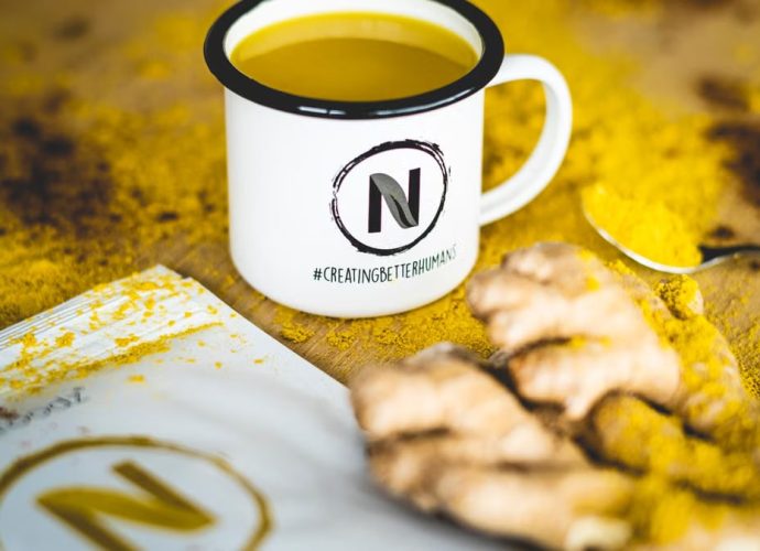 A close-up image of turmeric tea with fresh ginger root, perfect for health and wellness themes.
