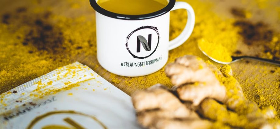 A close-up image of turmeric tea with fresh ginger root, perfect for health and wellness themes.